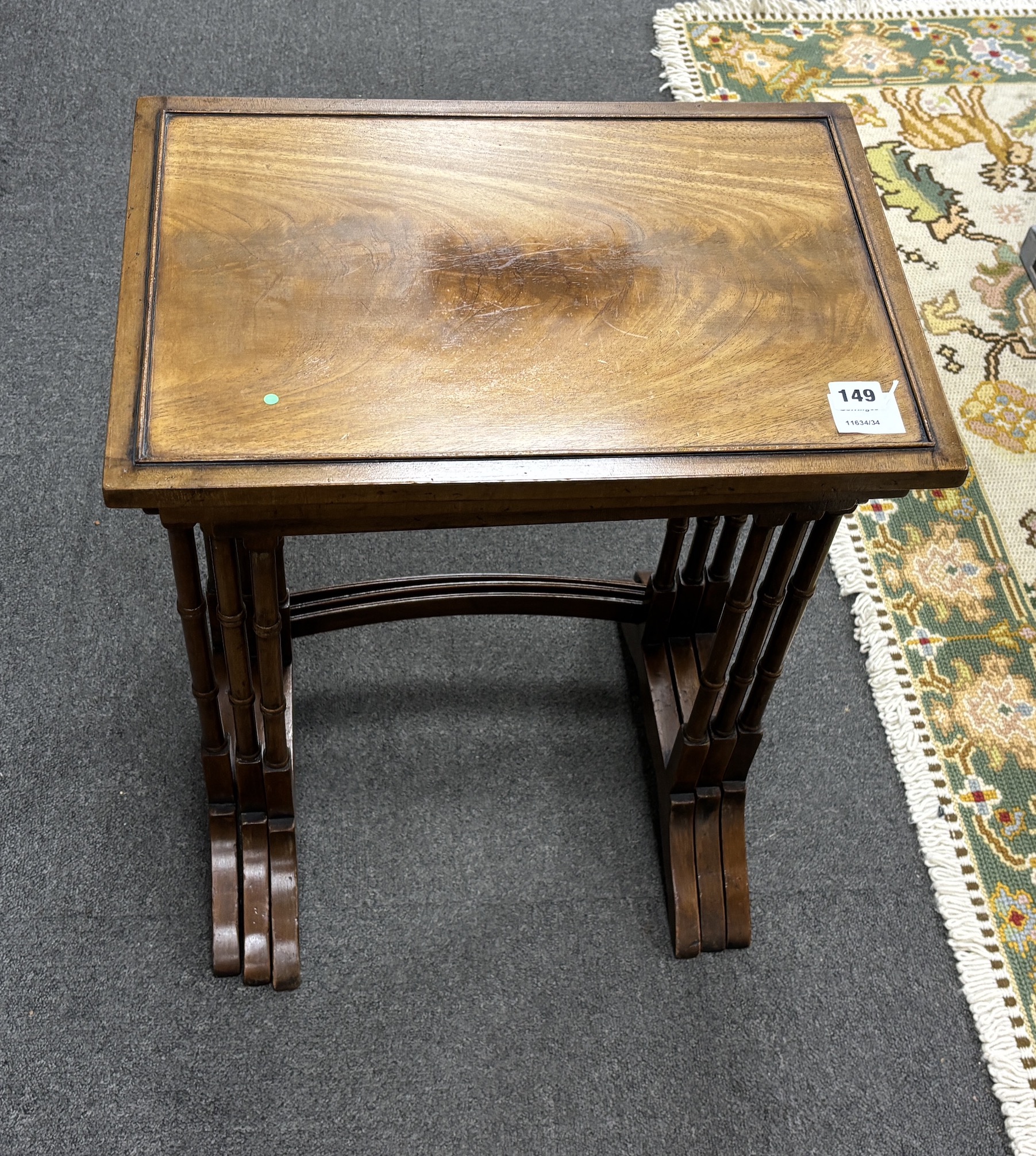 A nest of three Edwardian rectangular mahogany tea tables, on spindle turned legs, width 48cm, depth 33cm, height 60cm